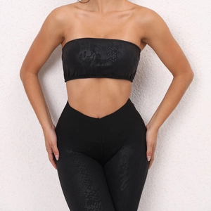 Detail of black snakeskin texture on strapless yoga top and high-waist leggings