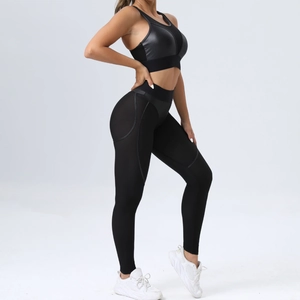 Chic black two-piece yoga set with mesh panels sports bra and high waist leggings