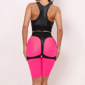Macro view of pink honeycomb mesh fabric and black paneling on athletic shorts