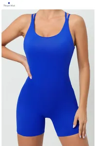 Detail of the back cross-strap design on a deep blue one-piece yoga bodysuit for women