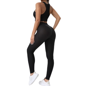 Women's black yoga set with mesh stitching, racerback bra and high waist leggings