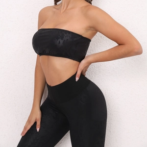 Close-up of black snake skin pattern on strapless sports top and yoga leggings set