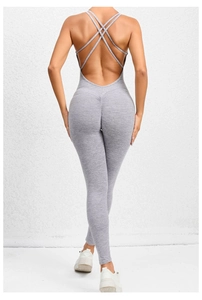 Close-up of gray backless yoga jumpsuit featuring cross straps and scrunch butt detail