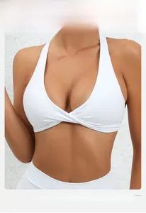 Detailed view of white yoga bra with V-neckline and criss-cross twist design for support