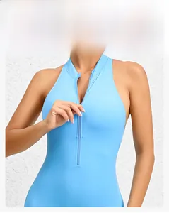Detail showing the half-zip collar and slim fit cut of the light blue yoga bodysuit