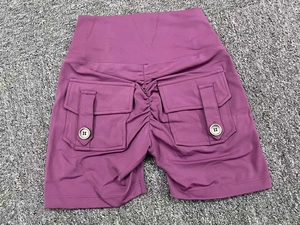 Macro view of high-waist scrunch butt yoga shorts with side pockets in plum purple