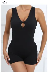 Front detail of black one-piece yoga jumpsuit with V-neck cross-knot and cutout design
