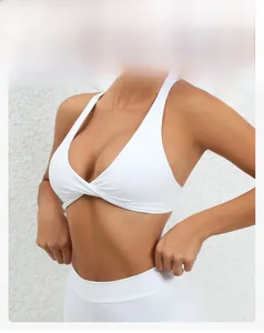 Detail of white V-neck sports bra featuring a twisted cross design and snug fit fabric