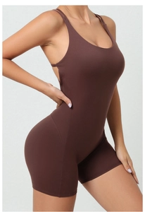 Side view detail of a brown one-piece yoga romper featuring thin straps and body shaping fabric