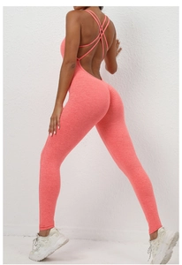 Close-up of coral pink scrunch butt yoga bodysuit with criss-cross back straps detail