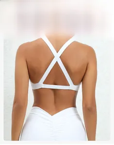 Detail of white yoga sports bra featuring a criss-cross back design and textured fabric