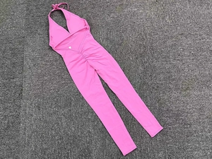 Pink backless yoga jumpsuit with lace-up neck and scrunch butt lifting detail