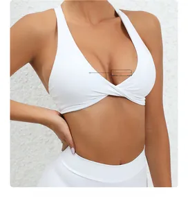 Detail of white cross-front yoga bra with removable pads and stylish twist design