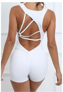Detail of white backless yoga jumpsuit with crisscross straps and ruched butt lift design