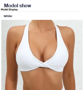 Detailed view of white yoga bra featuring a cross-front twist design and knit texture