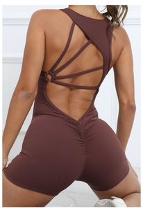 Close-up of ruched scrunch butt detail and criss-cross back straps on yoga romper