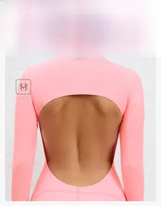 Detailed back view of pink long sleeve yoga bodysuit with open back oval cutout design