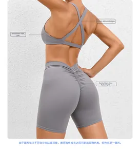 Back view of grey yoga set featuring a cross-back sports bra and scrunch butt gym shorts