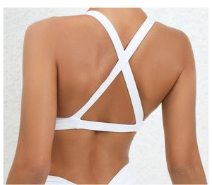 White sports bra featuring a criss-cross back design and wide elastic support band