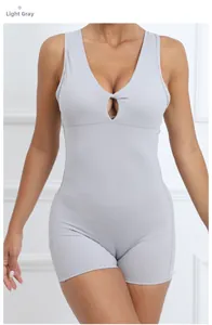 Close-up of light grey sleeveless yoga bodysuit with V-neck and hollow knot detail