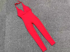 Flat lay of red backless yoga jumpsuit with deep V-neck and high elasticity fabric