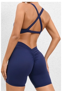 Detail view of the crisscross back sports bra and ruched yoga shorts in navy blue