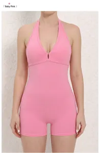Close-up of baby pink backless bodycon jumpsuit with halter neck and deep V-neck design