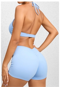 Detail view of light blue yoga jumpsuit showing scrunch butt design and high waist fit