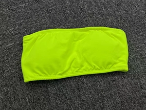 Close-up of fluorescent yellow strapless yoga tube top with elastic ribbed fabric texture