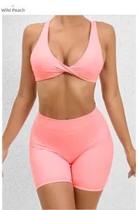 Detail of cross-back yoga top and high-waist shorts in wild peach quick-dry fabric