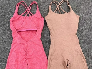 Detail of cross back straps and ruched butt lifting texture on two yoga bodysuits