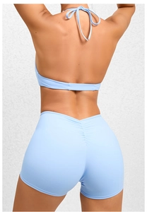 Detail of light blue backless yoga jumpsuit featuring ruched bum lifting texture
