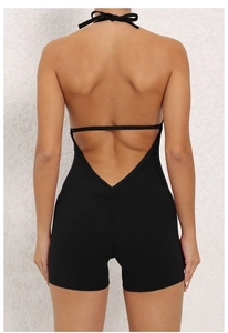 Back view of black halter yoga jumpsuit with backless design and ruched peach butt detail