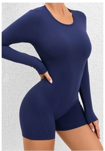 Detail of navy blue long sleeve yoga romper showing fit and flexible athletic fabric