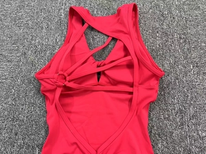 Detailed back view of red yoga jumpsuit featuring intricate criss-cross strappy design