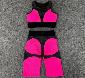 Detailed flat lay of neon pink and black two-piece yoga set with breathable mesh fabric