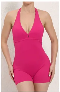 Detail of magenta backless yoga bodysuit showing deep V-neck and reinforced stitching