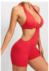 Macro shot of red backless yoga jumpsuit with side cut-outs and high-stretch fabric