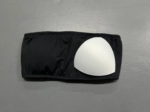 Detail view of black strapless yoga bandeau with removable white triangle pads
