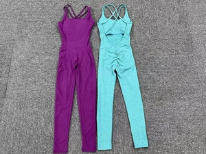 Detail of cross-back yoga jumpsuits in purple and cyan with scrunch butt lifting texture