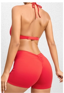 Rear view of red backless yoga jumpsuit with scrunch butt lifting shorts design