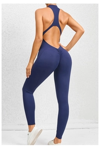 Detail of navy yoga jumpsuit featuring an open back design and ruched lifting effect