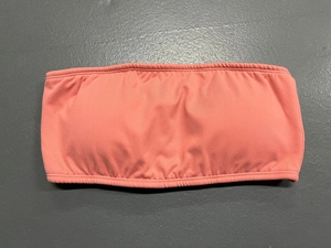 Detail of coral pink strapless yoga tube top with elastic ribbed knitted texture