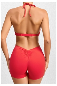 Rear view of red two-piece yoga set featuring ruched scrunch detail on fitness shorts