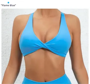 Detail view of flame blue sports bra with V-neckline and front knot design for yoga