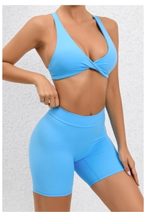 Detail view of sky blue two-piece yoga set featuring cross-back bra and high-waisted shorts
