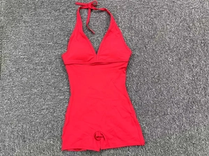 Detail view of a red high-elasticity one-piece bodysuit with halter neck and boy-leg cut