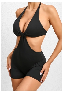 Close-up of black one-piece yoga jumpsuit featuring side cut-outs and ruched V-neckline
