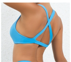 Close-up of bright blue sports bra featuring cross-back straps and moisture-wicking fabric