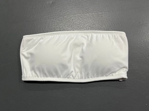 Detailed view of white strapless bandeau bra with high elastic fabric and ruched center